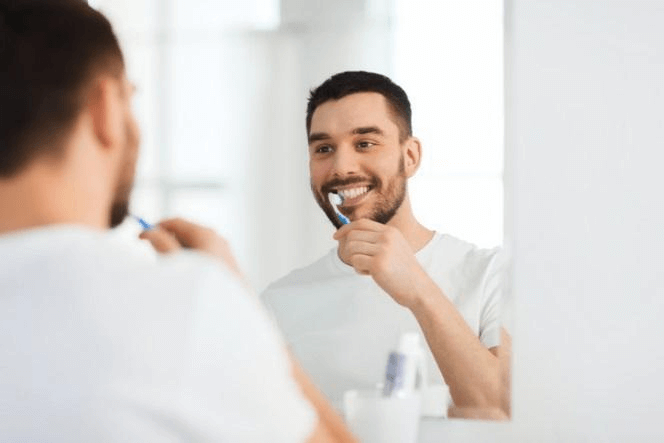 Male brushing his teeth