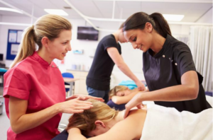 Massage therapy training students during their clinical training component