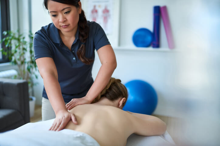 Massage therapist massaging a client