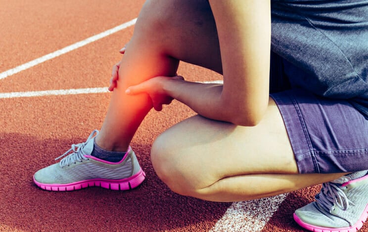calf stretching on a running track