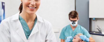 Portrait of dental assistant smiling with dentistry work in the background