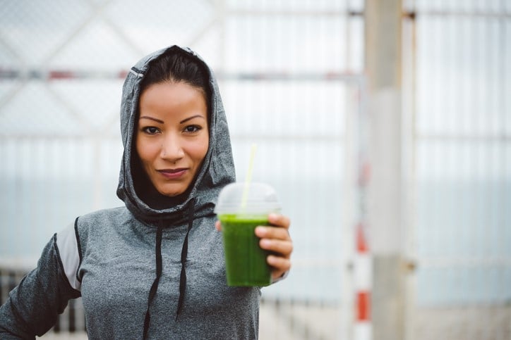 female holding a protein shake
