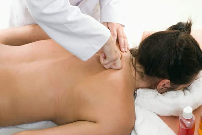 massaging upper back of client
