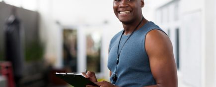 handsome african american male trainer with clipboard