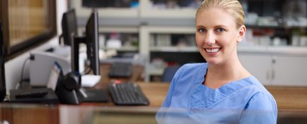 Woman working as nurse at reception desk in clinic