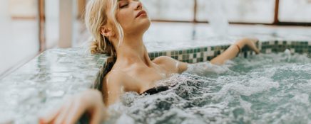 Young woman relaxing in the whirlpool bathtub