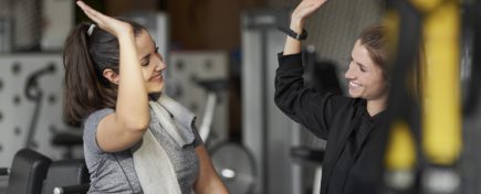 Sporty couple high five at gym