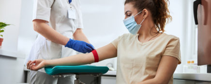 Experienced Medical Lab Tech preparing a woman for blood draw