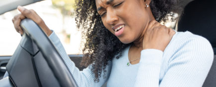 Female driver feeling neck pain, back muscle inflammation