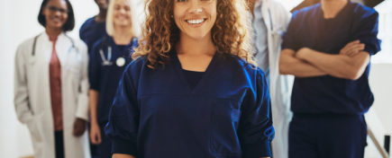 Smiling medical team standing together in a hospital