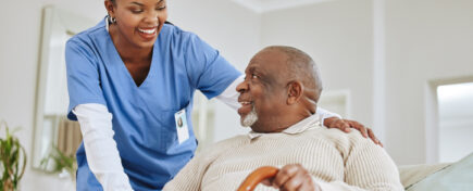 A Personal Support Worker speaking to her patient