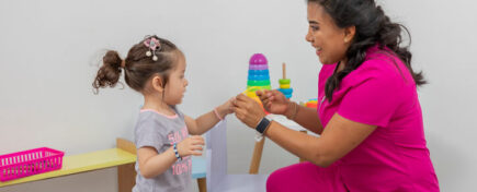 Caregiver interacting with a female child after Early Childcare Assistant Training