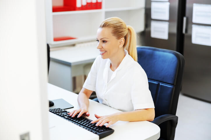 Female dental office administrator using a computer in an office