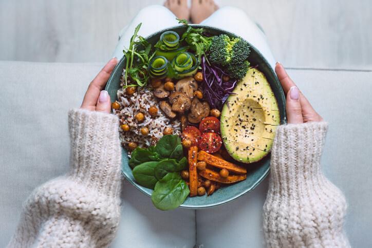 Health promotion programs professional holding a vegan bowl