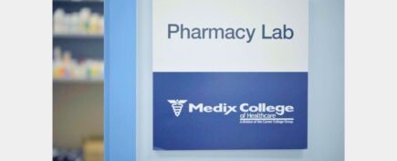 A pharmacy assistant course student's view of the Medix College Pharmacy Lab sign during training.