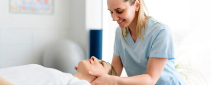 A massage therapist massaging a client’s neck