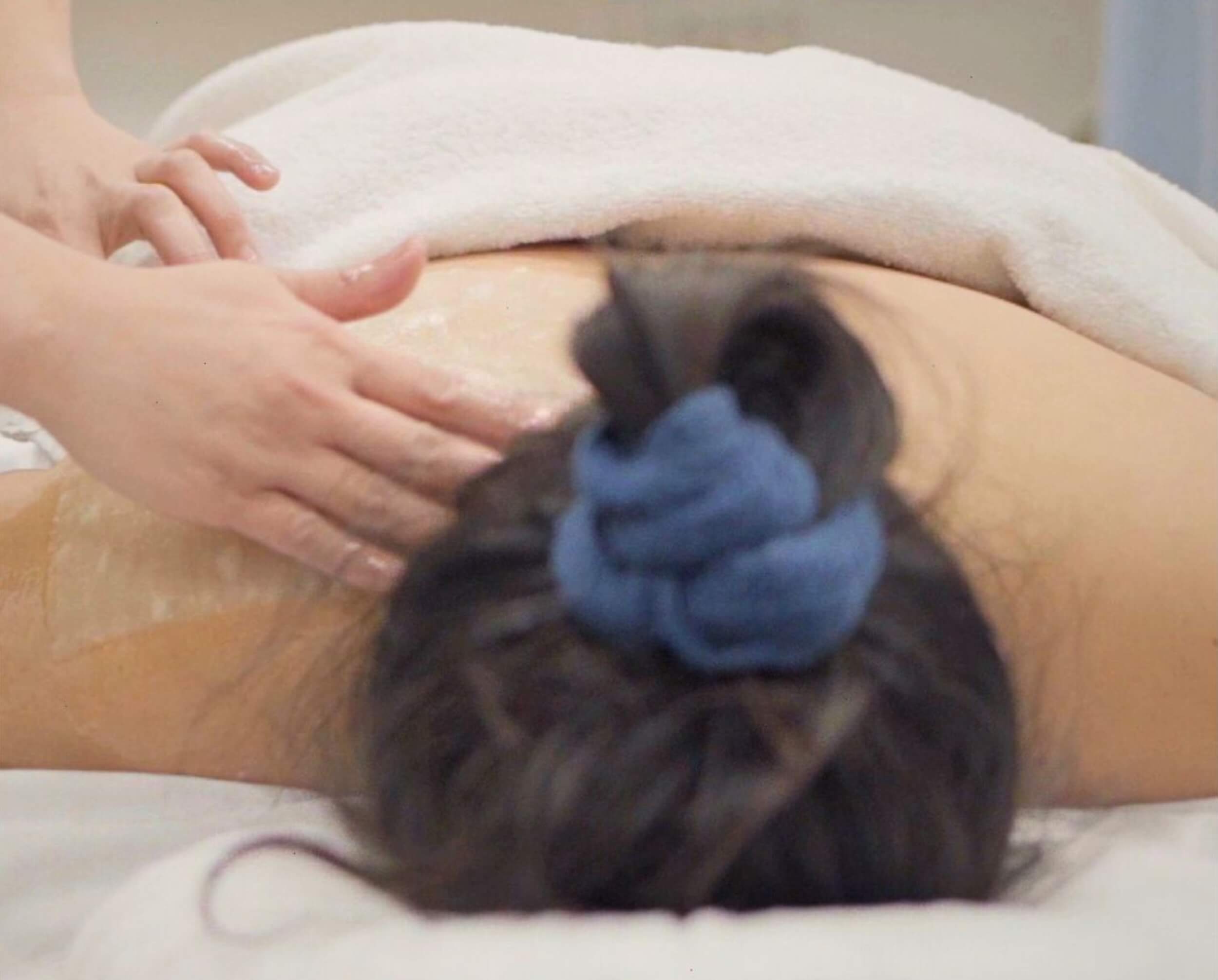 A massage therapist massaging a client’s back