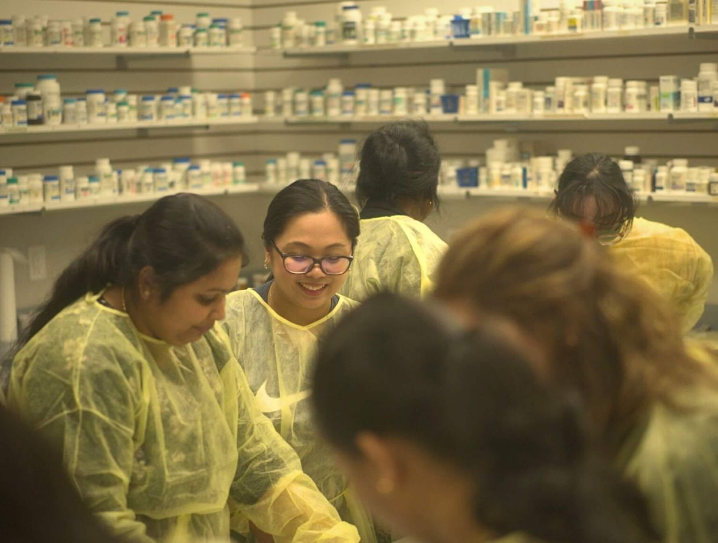 A group of Pharmacy Assistant course students working together on a project