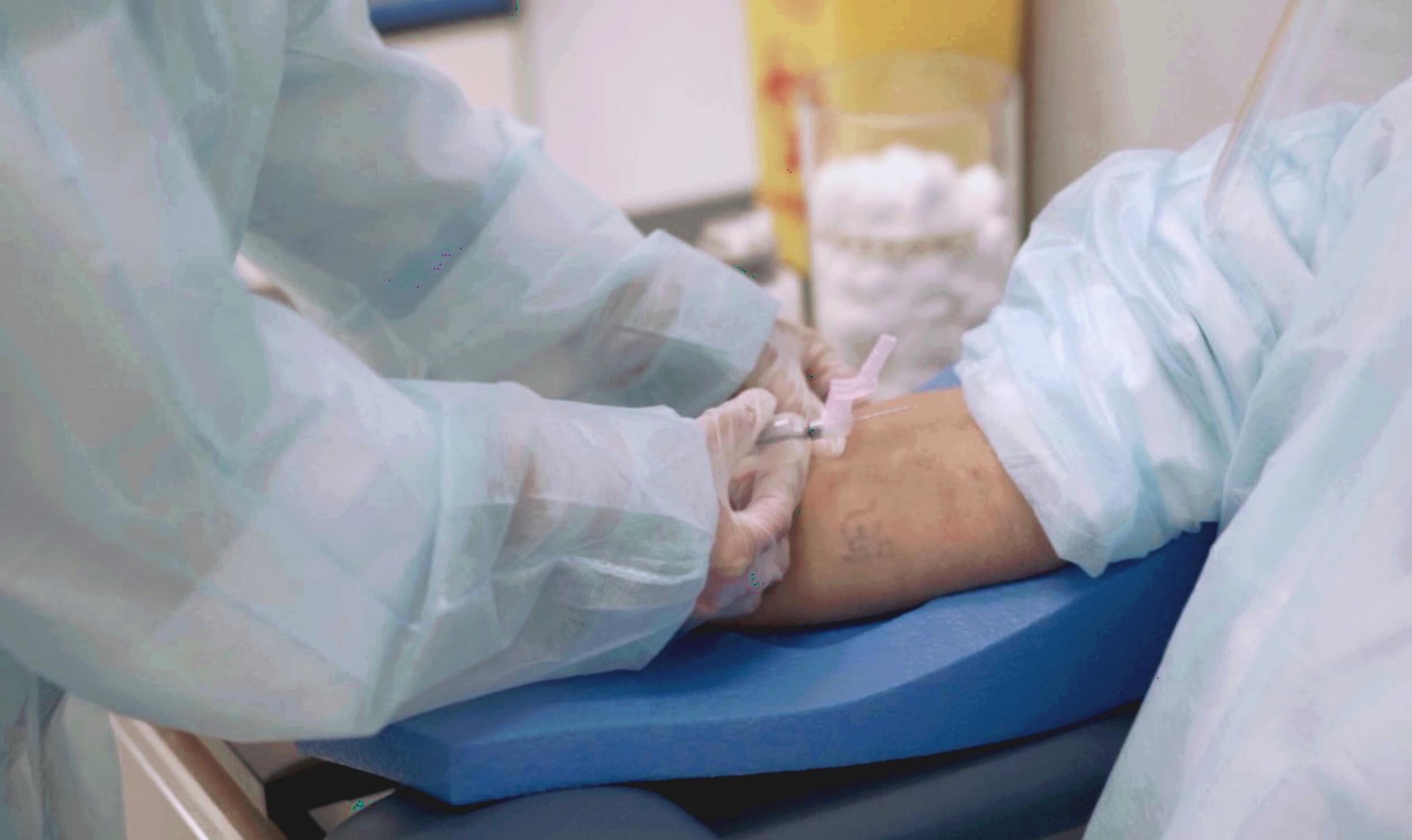 A medical laboratory assistant taking a blood sample after completing her medical lab assistant/technician program