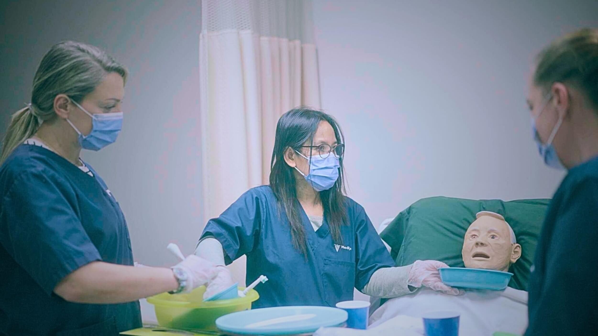 Female PSWs monitoring a patient after completing their personal support worker online course