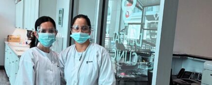 A pair of dental assisting program students in front of Medix College Logo