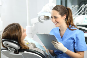 female dental administrator with a patient