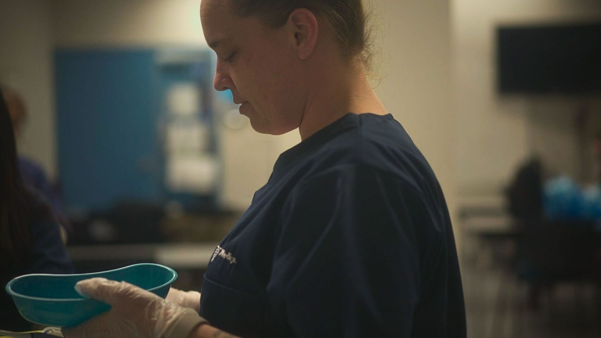 A student learning PSW responsibilities using medical instruments