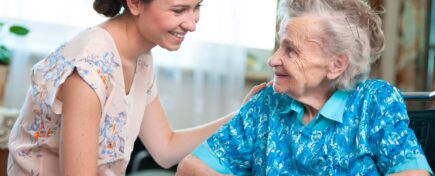 A community support worker talking to an elderly lady.