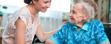 A community support worker talking to an elderly lady.