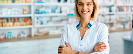 A confident female pharmacy assistant at work after completing her pharmacy assistant program