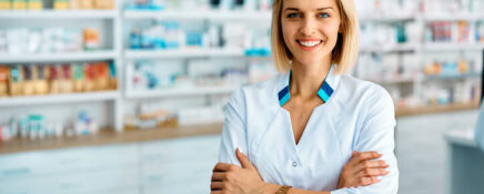 A confident female pharmacy assistant at work after completing her pharmacy assistant program