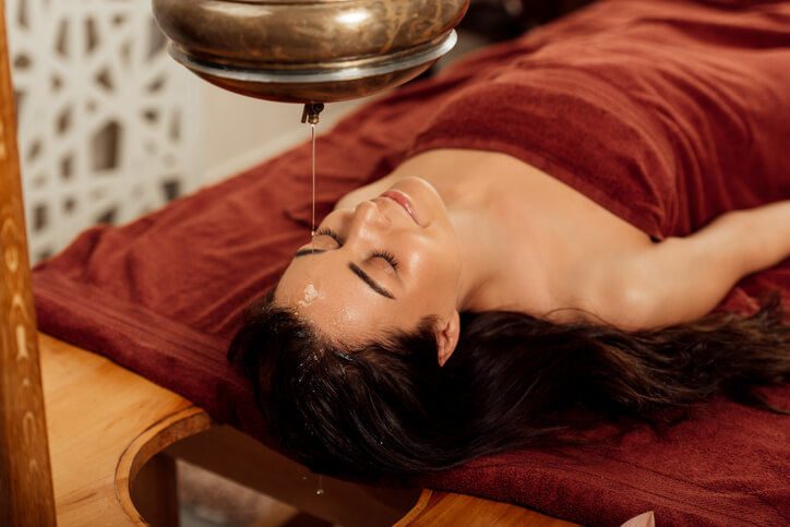 Massage therapist with a female client after completing her massage therapy courses.