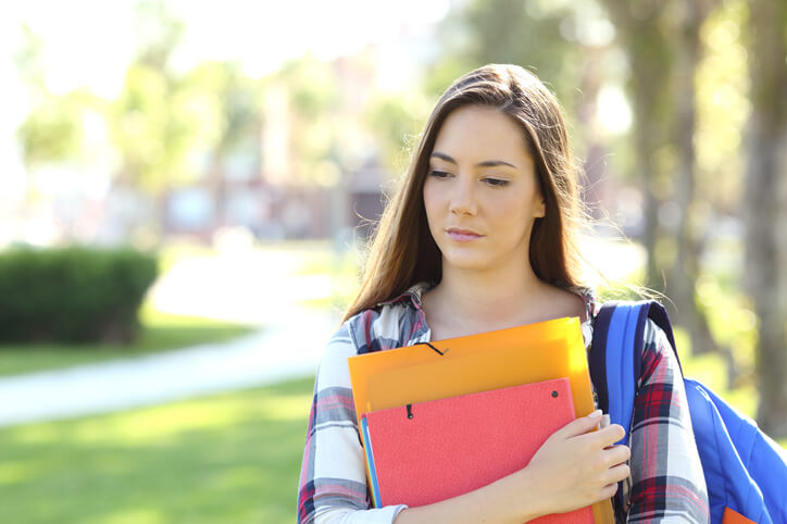 A career college student walking to class holding books