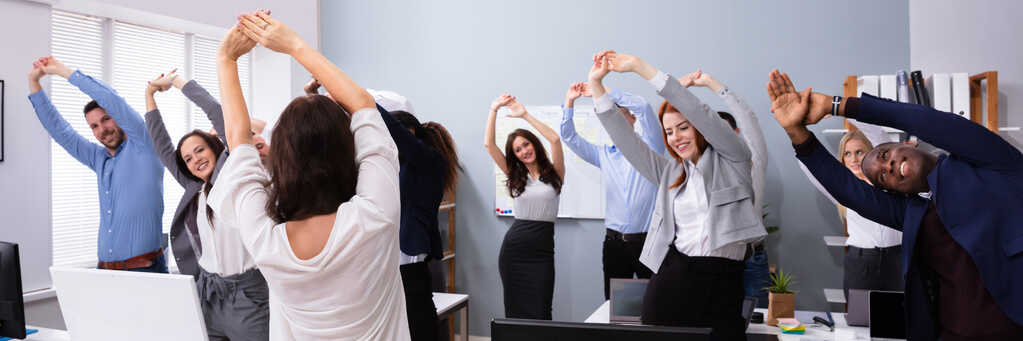 Employees participating in a corporate wellness program, engaging in a wellness challenge or group fitness class, emphasizing health and fitness career opportunities.