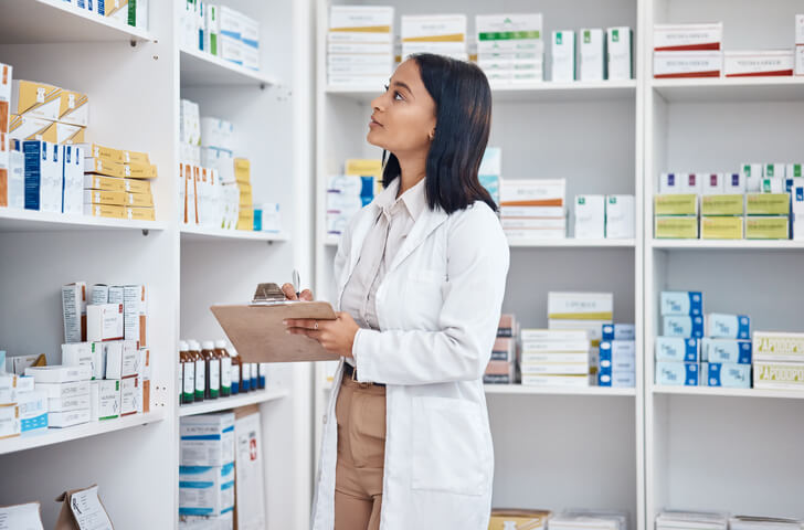 A pharmacy assistant program grad organizing pharmacy inventory