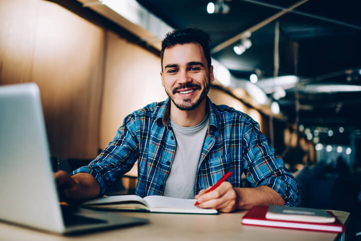 A student following a study schedule by completing tasks in the library