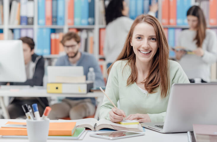 Career college student browsing free learning resources on a laptop during her healthcare career training in Ontario