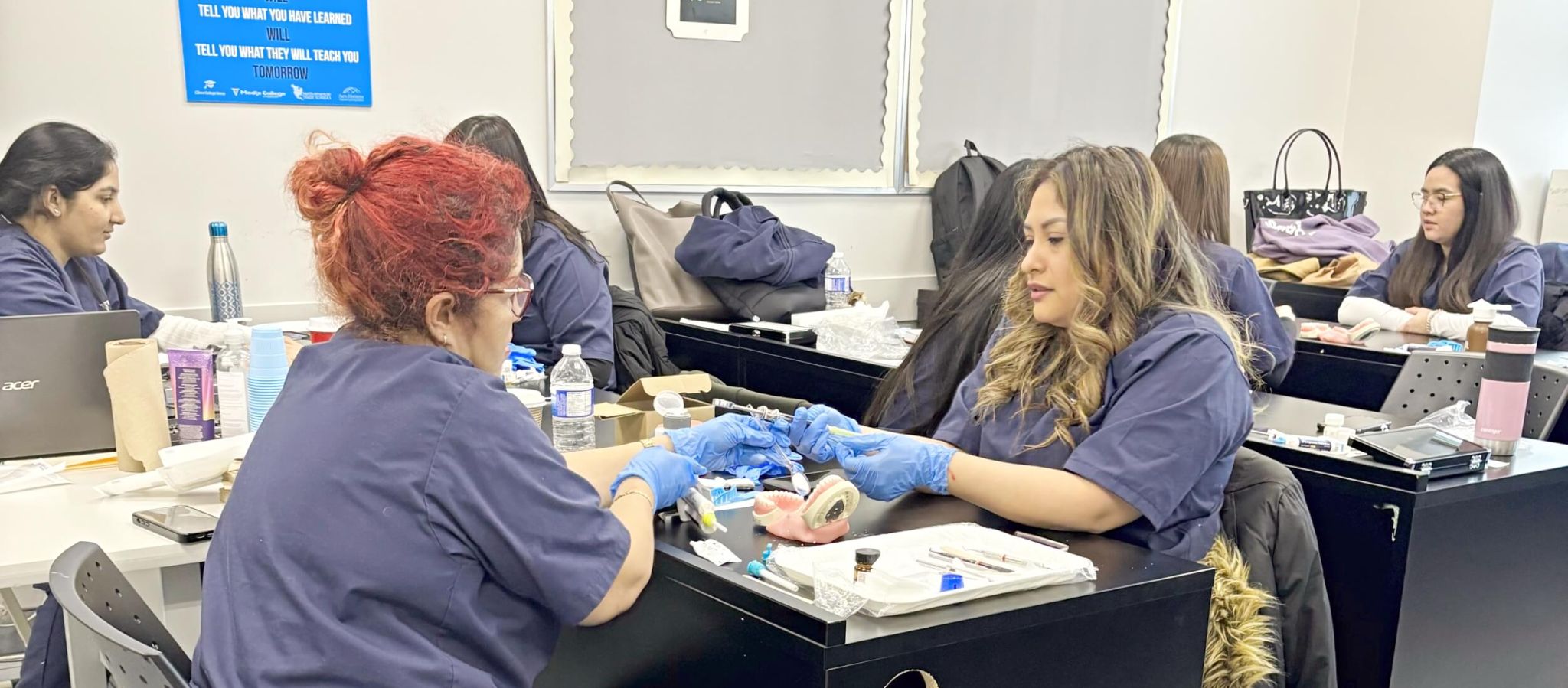 Students of our dental assistant program in Toronto practicing dental procedures in a hands-on classroom setting