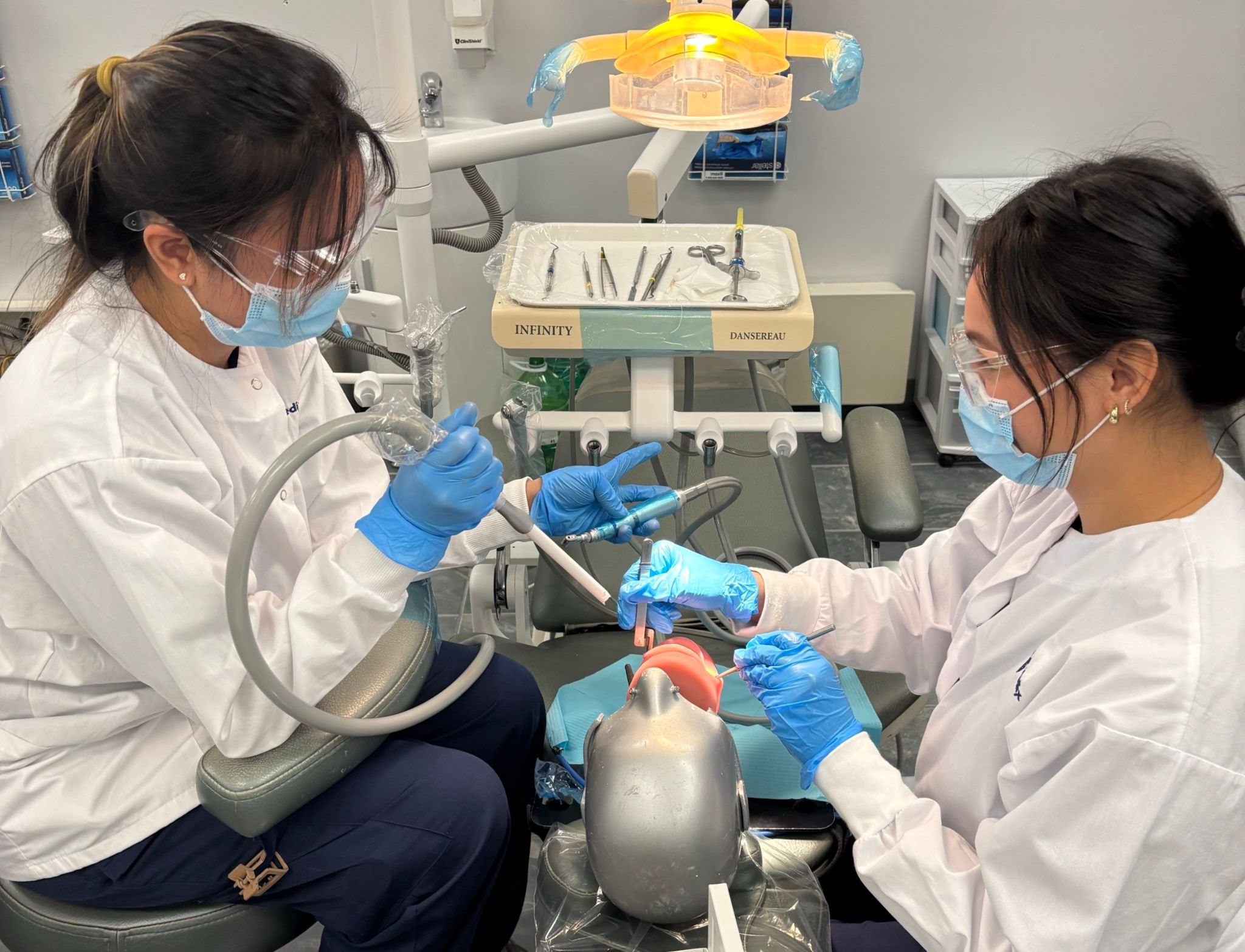 Learners gaining chairside experience with dental tools in our dental assistant program in Toronto