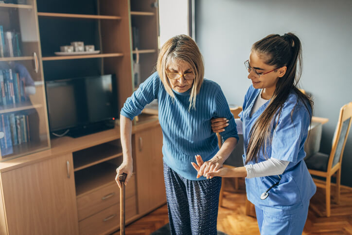 A PSW assisting a senior patient at home
