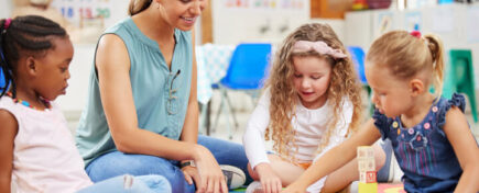 An early childhood assistant engaging children in a classroom activity