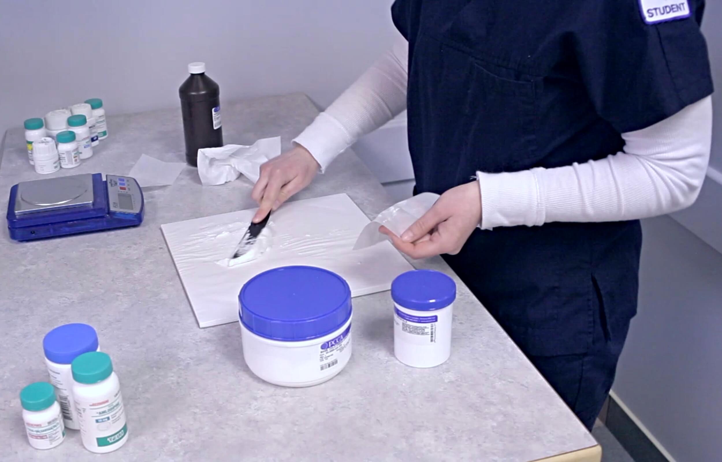 A class of pharmacy students preparing a topical cream in class