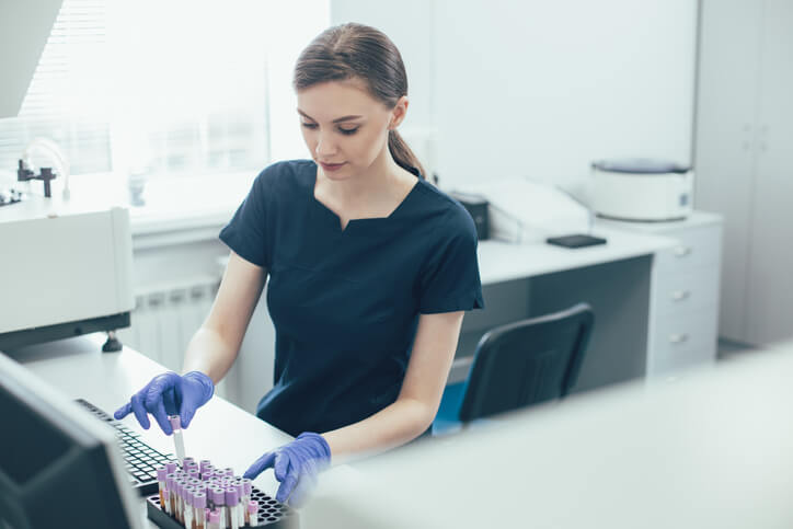 A medical lab assistant preparing blood samples